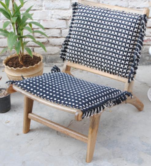 low wooden folding chair, black and white upholstery 
